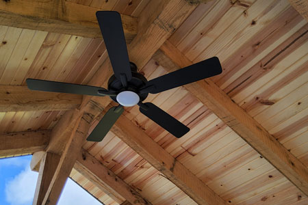 Ceiling fan on wooden ceiling with beams